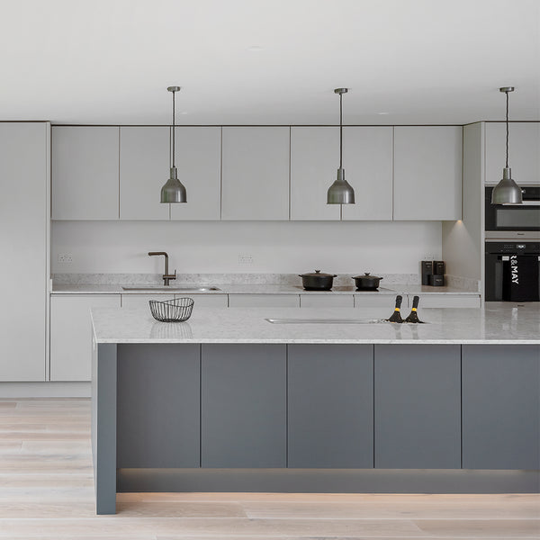 A white minimalist kitchen interior with metal lights by Industville