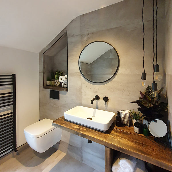 A minimalist industrial bathroom interior with hanging lights