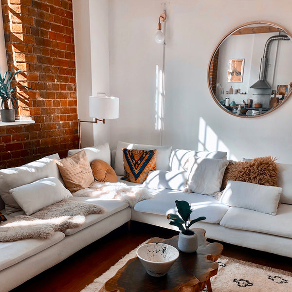 A light living room with wooden features and industrial lighting