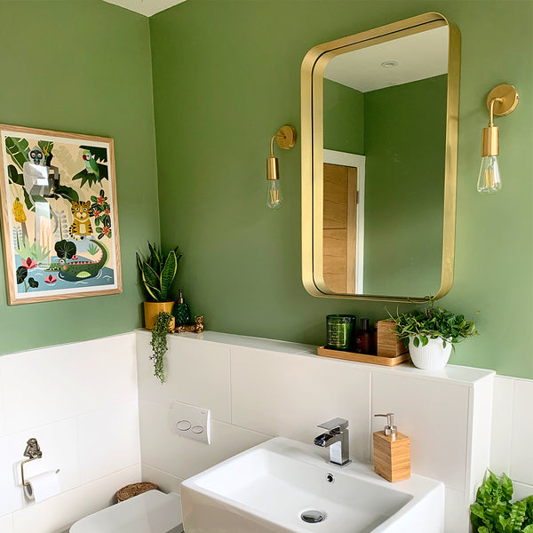 A green contemporary bathroom with brass lighting by Industville