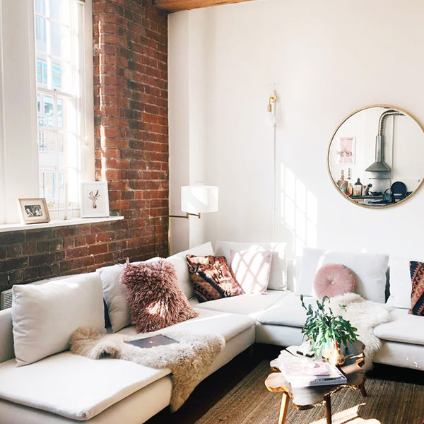 Shabby chic living room interior with exposed brick wall and industrial lighting 
