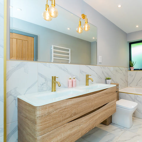 marble effect bathroom with light wood furniture