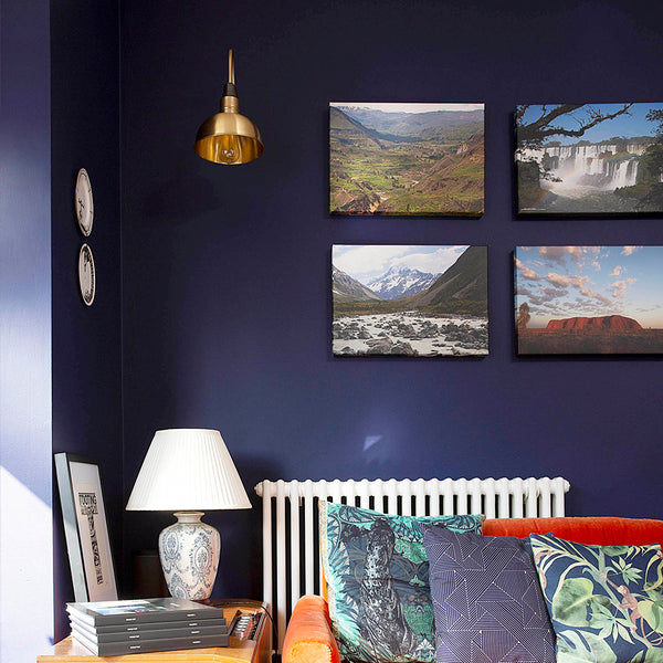 A modern living room with dark blue wall and orange sofa