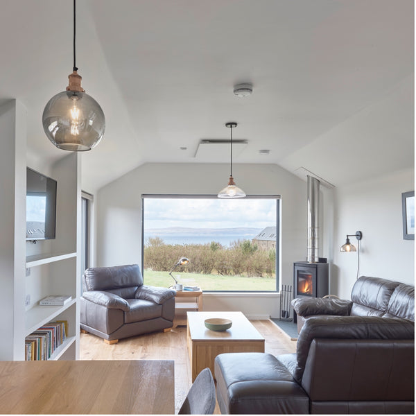 A room decorated with a glass shade pendant