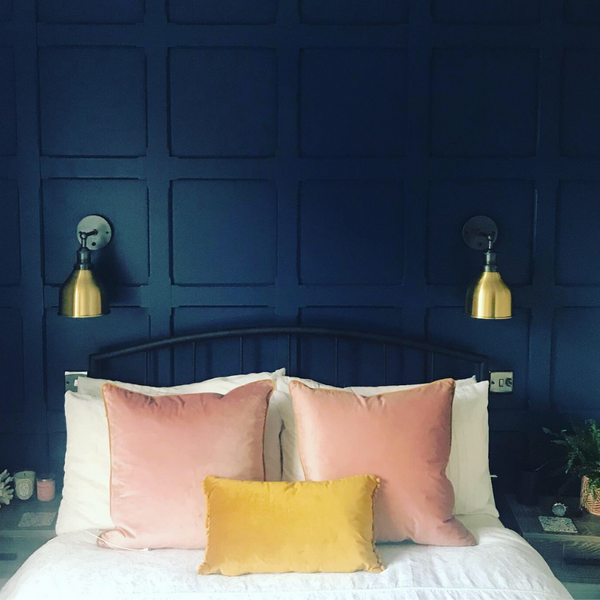 A blue panelled wall in a bedroom