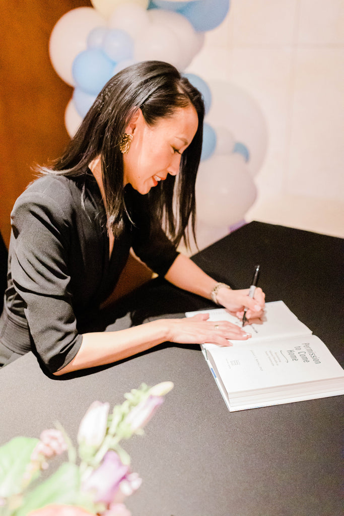 Dr. Wang autographing her book at a signing.