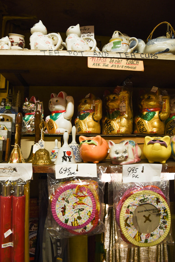 Shelves of the Fortune Cat, or Maneki Neko. It is a lucky cat charm that's very popular in Japanese and Chinese cultures. It is believed to attract good luck and fortune, so it is often displayed in homes and businesses. 