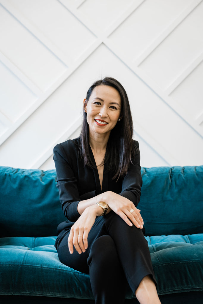 Dr. Wang sitting on a teal couch.