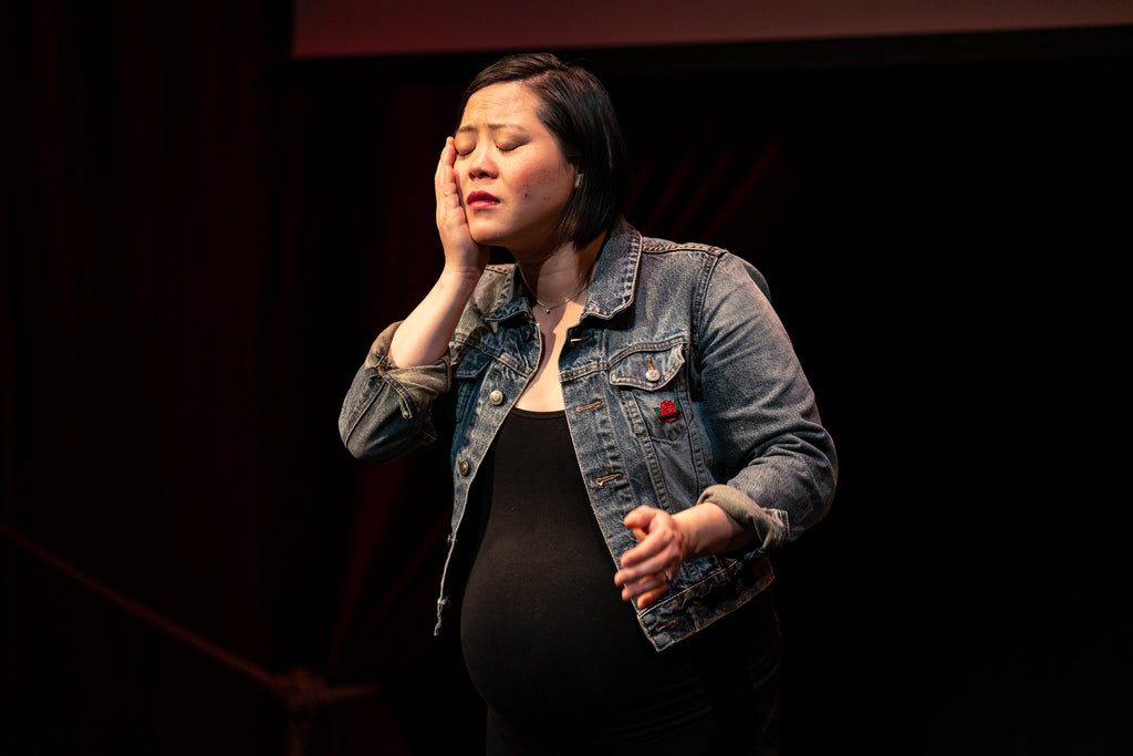 Susan Lieu performing her one woman play "140 LBS: How Beauty Killed My Mother" while she was pregnant.