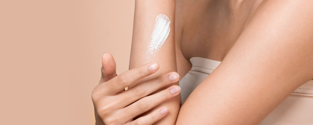 Womans Arm and Hand with lotion on it