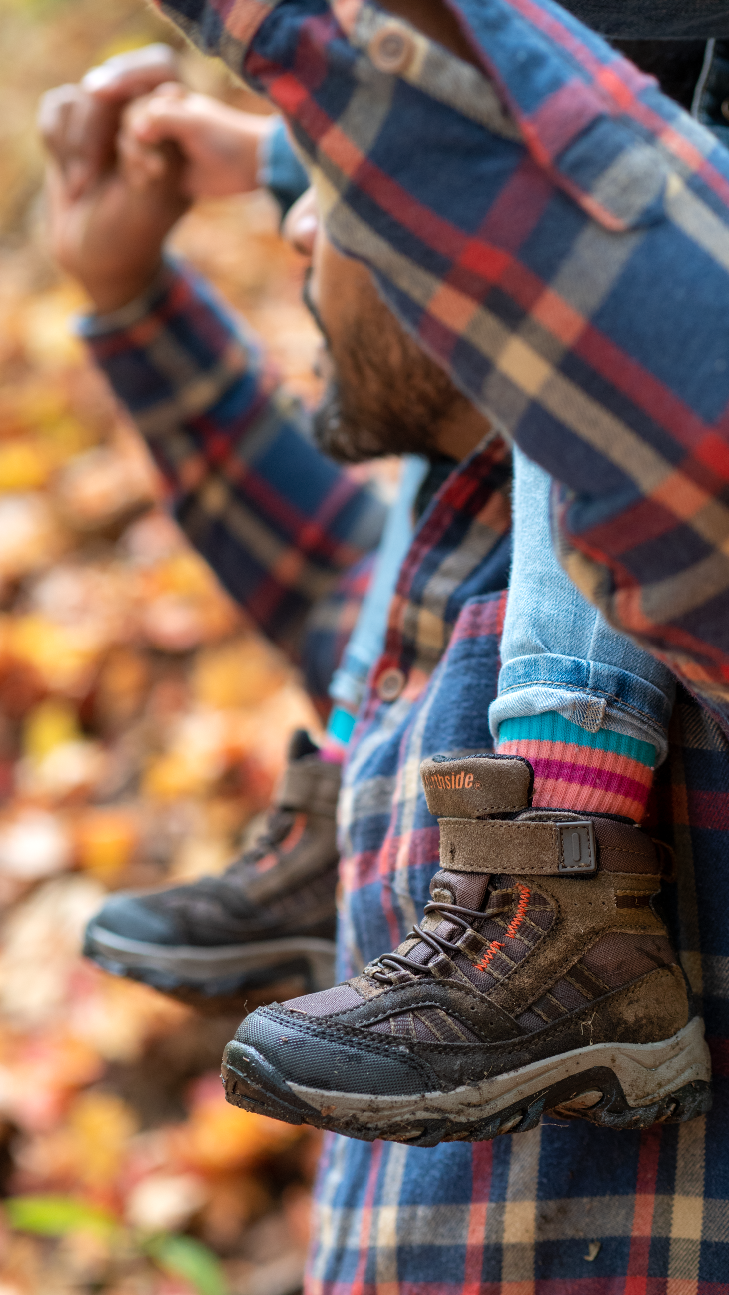 toddler hiking boots featured while child is on fathers shoulders