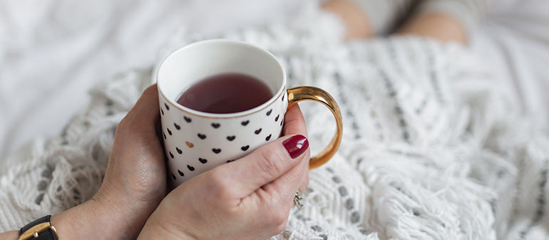 Image of woman holding tea cup