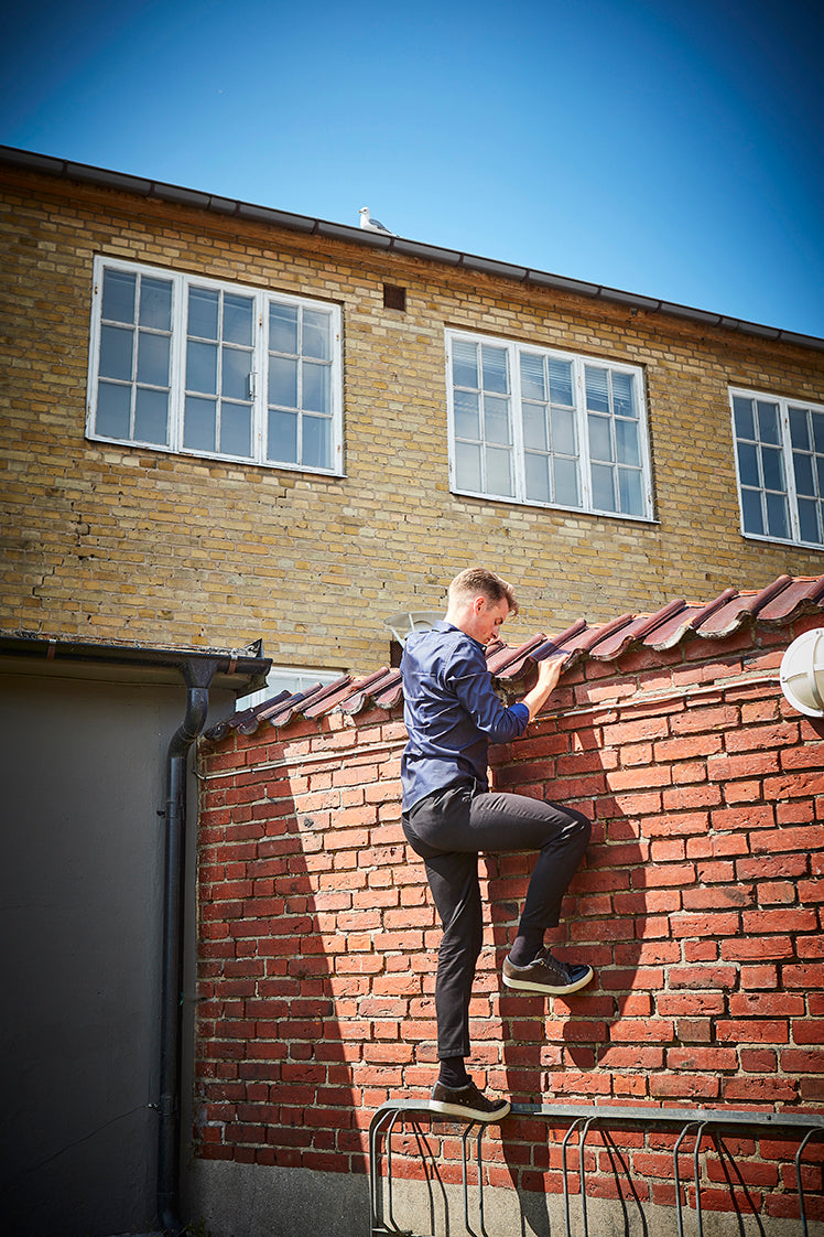 John climbing a brick wall