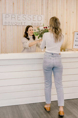 Client dropping off flowers during their flower drop off appointment