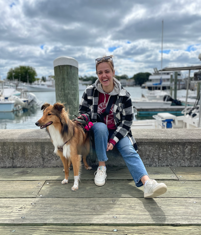 Nikole with her dog Mango at the shore.