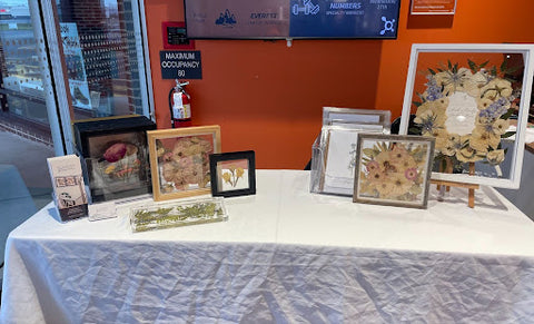 A table set up at Orange Theory in Allentown, PA with pressed flower frames and functional resin keepsakes.