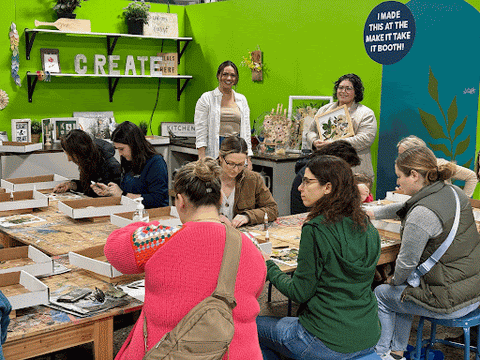 Two workers from Element teaching a class to create a pressed flower frame at the Philly Oak Home Show.