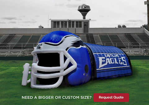 blue inflatable helmet with tunnel entrance on a football field 