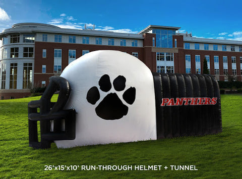 inflatable helmet with tunnel entrance on a grass lawn
