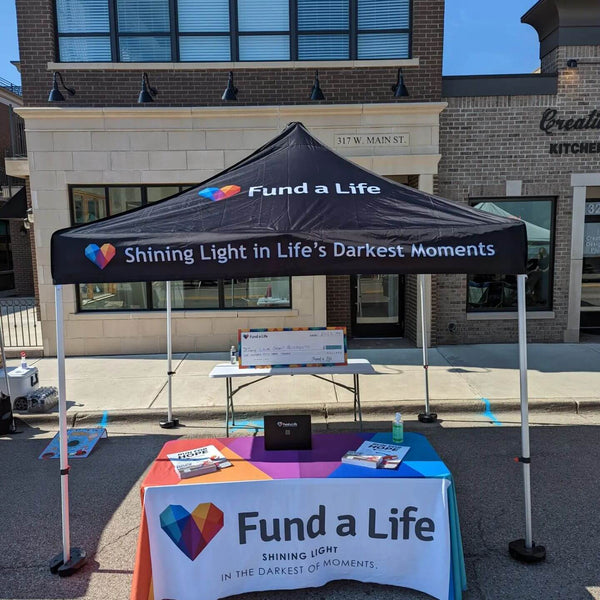 fund a life canopy tent secured with leg weights