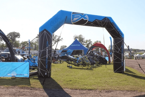inflatable arch secured to the ground with ropes and anchors