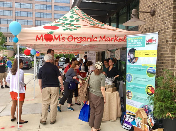 MOM's Organic Market booth highlighting environmental commitment and community engagement