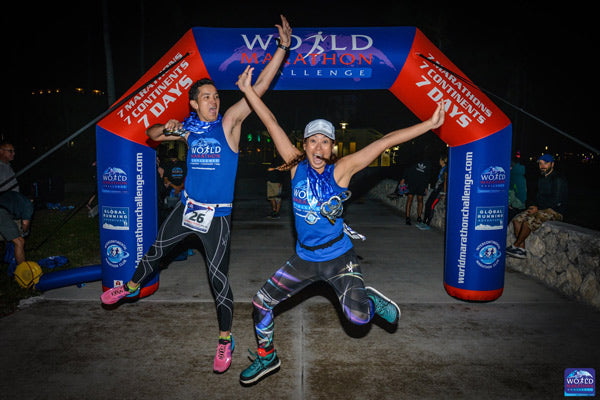 athletes happily jump at World Marathon Challenge Custom Inflatable Arch