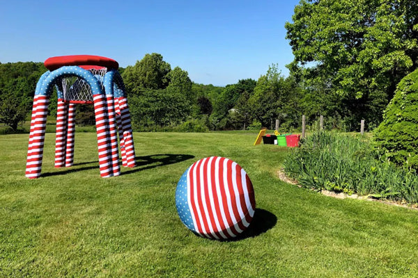 blue, red and white inflatable ball and basket on open field