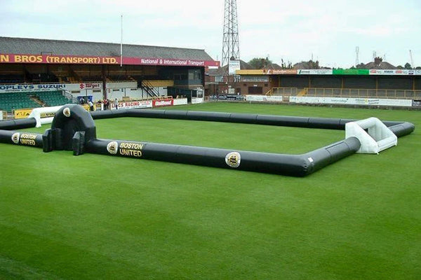 green inflatable soccer field with logo on the sides