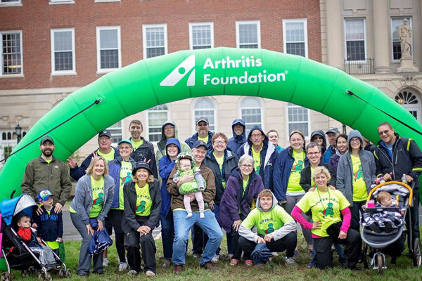 group photo in front of a stunning inflatable archway