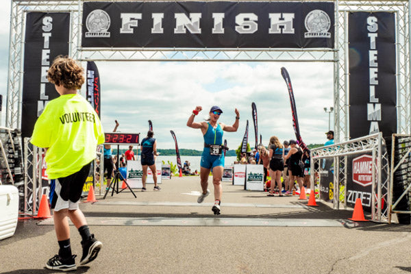 happy athlete at custom inflatable finish arch line