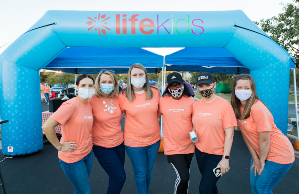 ladies pose for photo at lifekids Custom Inflatable Arch