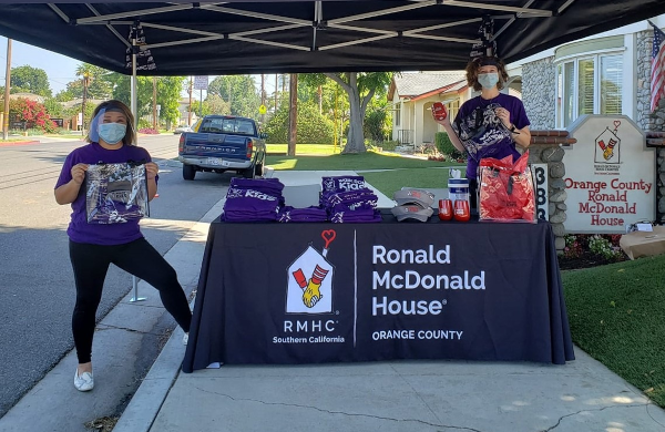 people next to table with Ronald McDonald House Custom Tablecloth