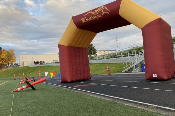 red and yellow custom inflatable arch tunnel on race track