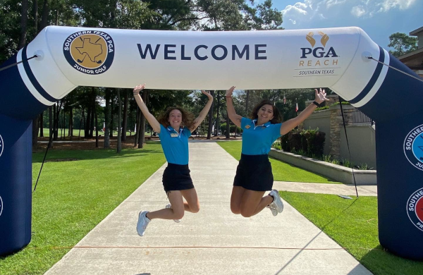two ladies jumping happily at Southern Texas PGA Golf inflatable arch