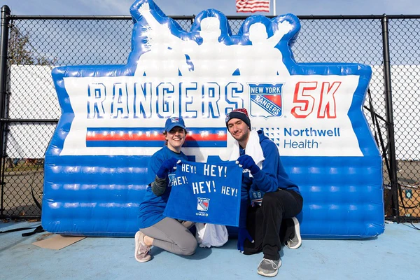 athletes pose for photo at Rangers 5K custom inflatable