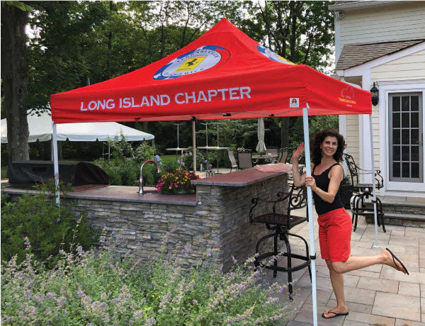 woman posing next to customized tent