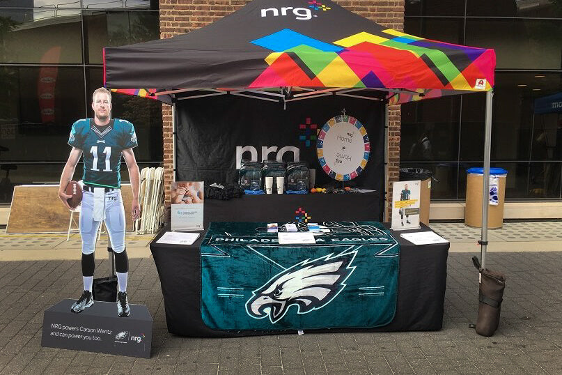 nrg branded event tent with a cardboard cut out of philadelphia eagles football player