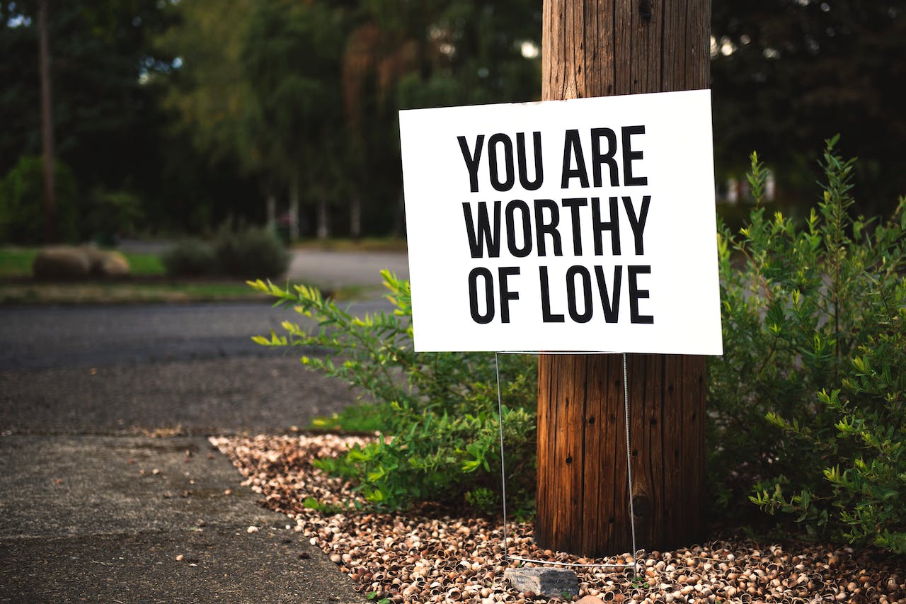 roadside sign with the word you are worthy of love