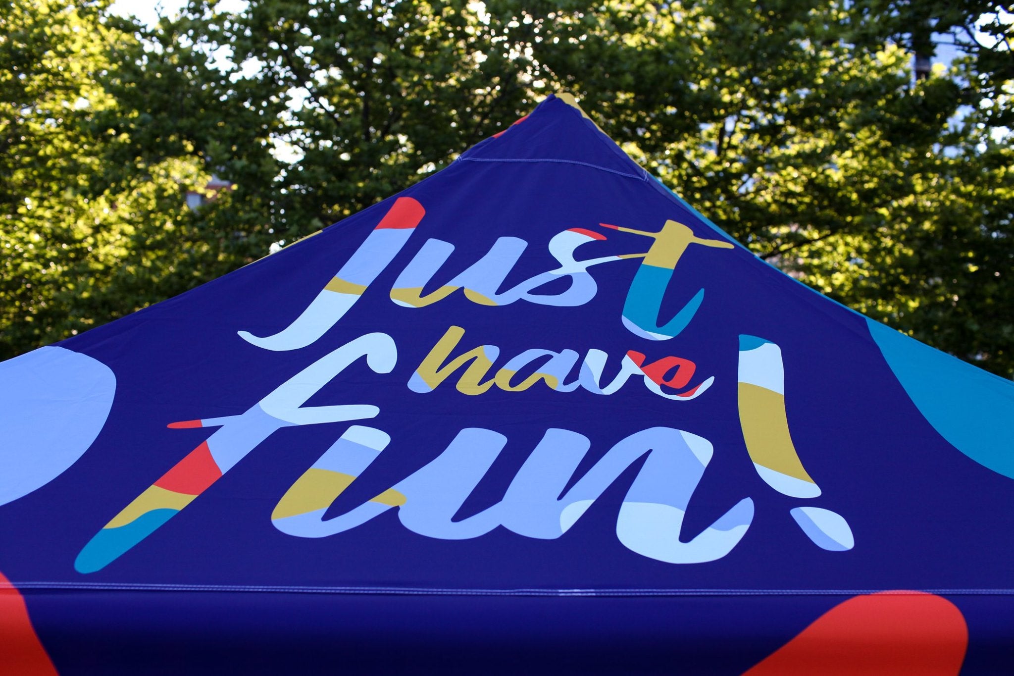 a canopy tent featuring a slogan that says just have fun