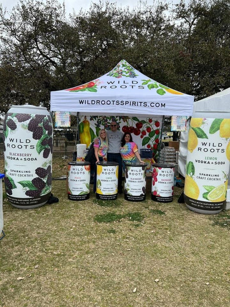 Wild Roots Spirits booth promoting their range of fruit-flavored vodka cocktails