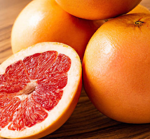 citrus extracts grapefruit whole and sliced on table - Culinary Solvent