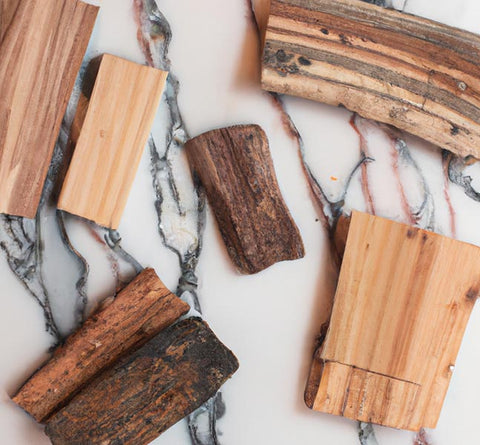 diy perfumers various wood planks on marble table - Culinary Solvent