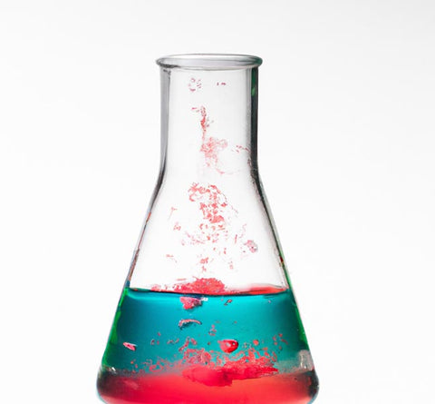 researchers scientists blue red chemical reaction in beaker - Culinary Solvent