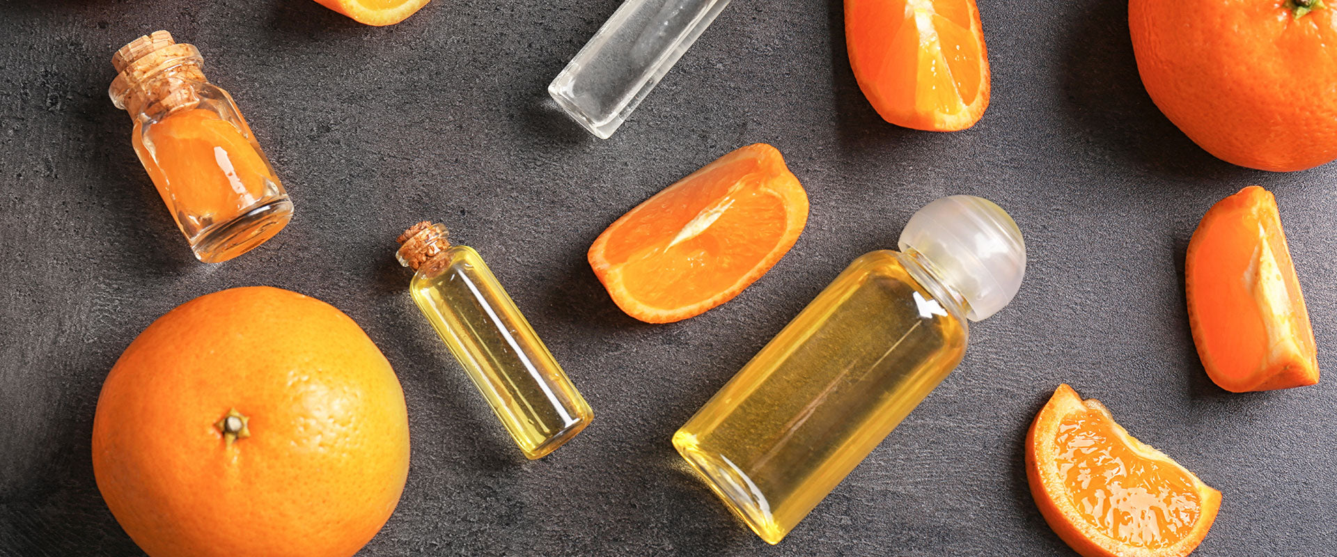 citrus extract made with food grade alcohol in glass bottles with orange slices