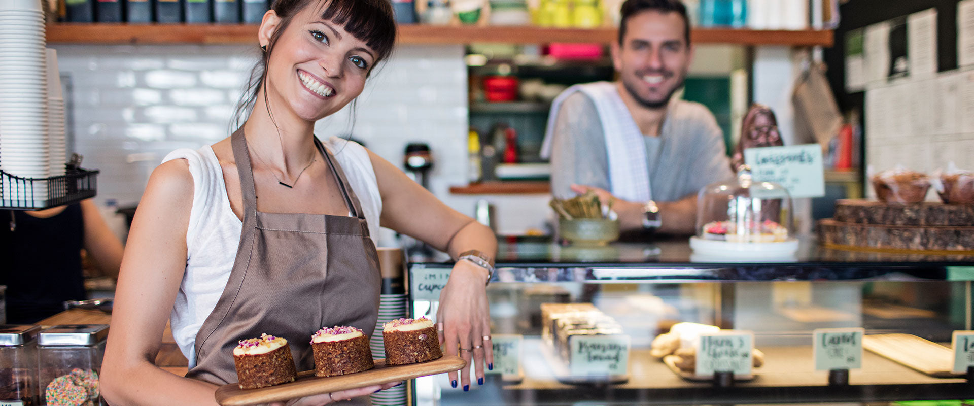 happy female baker holding fresh baked goods made with 200 proof food grade alcohol by Culinary Solvent