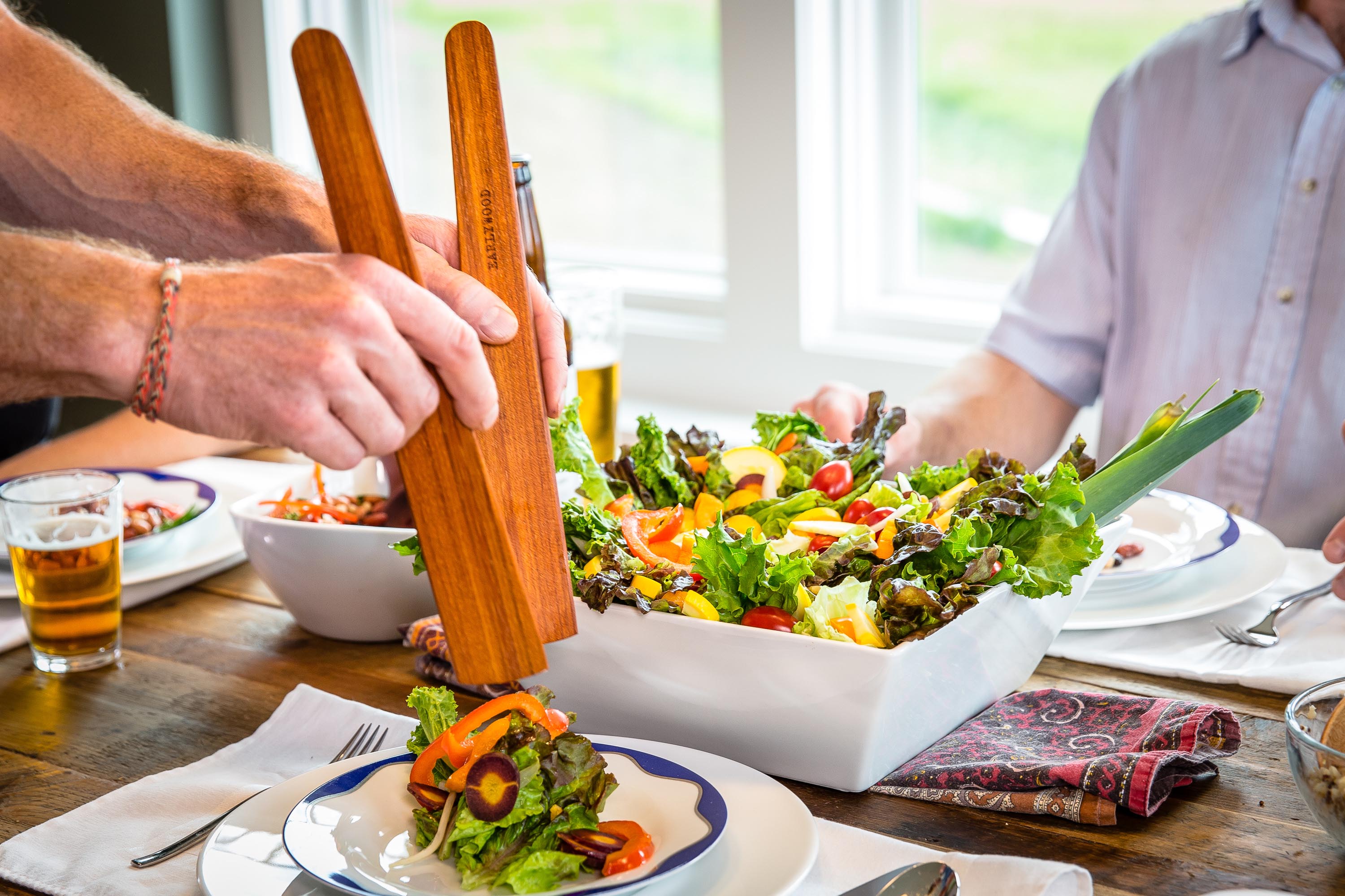 Two wood spatulas for serving salad