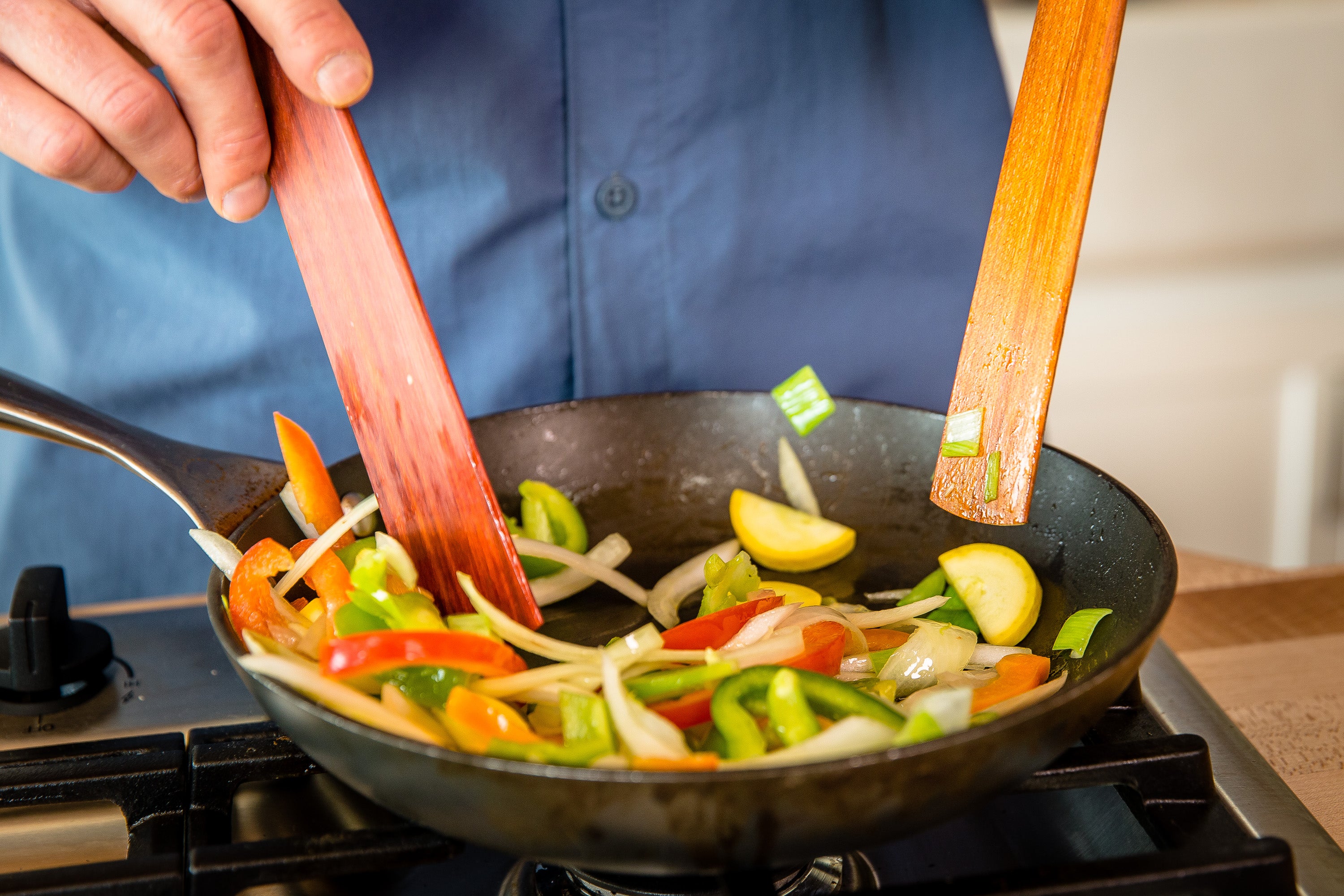 Using head or blade of wooden spatula for sautéing