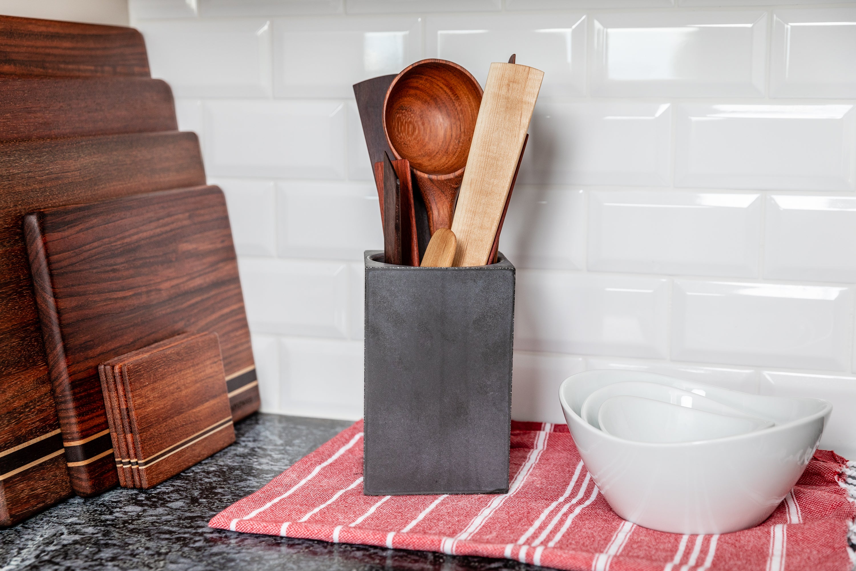 Fanned display of a variety of different wooden kitchen utensils