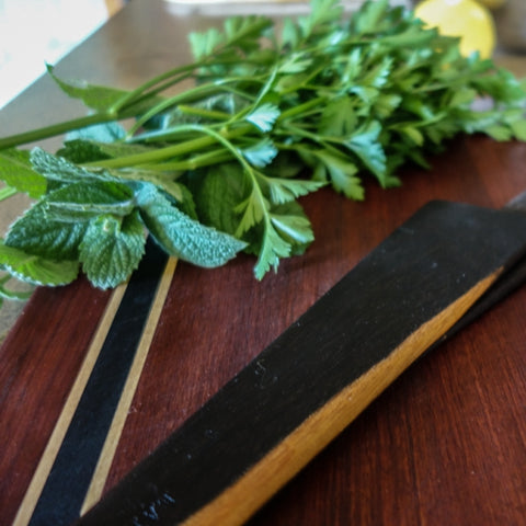 wooden utensils cutting board scraper fresh herbs